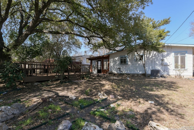 back of house featuring a deck and central AC unit