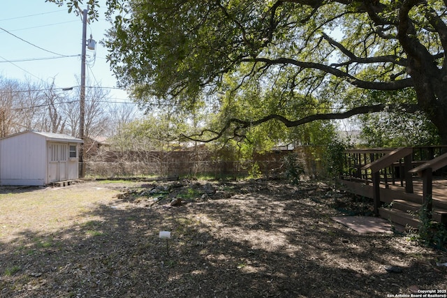 view of yard with an outbuilding, a fenced backyard, and a storage unit