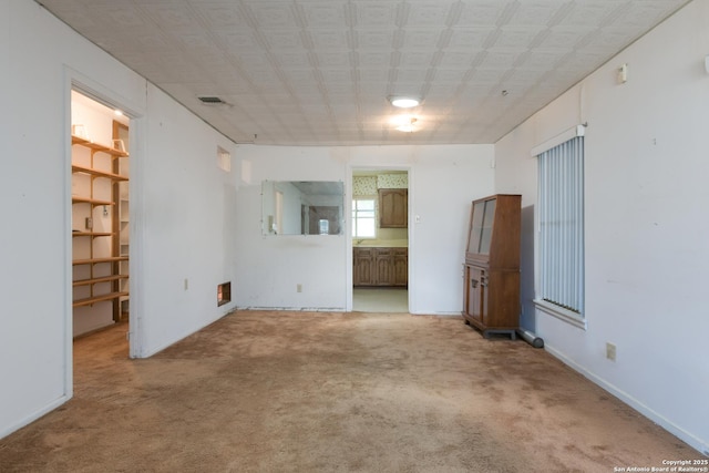 unfurnished living room with carpet flooring and visible vents