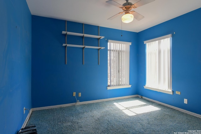 spare room featuring carpet floors, baseboards, and a ceiling fan