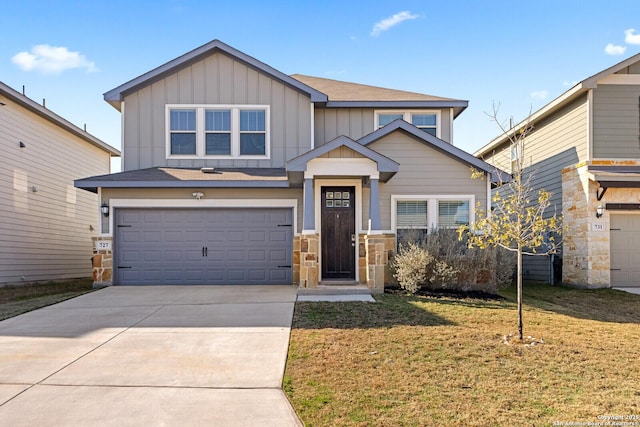 craftsman-style house featuring an attached garage, a front yard, board and batten siding, and concrete driveway