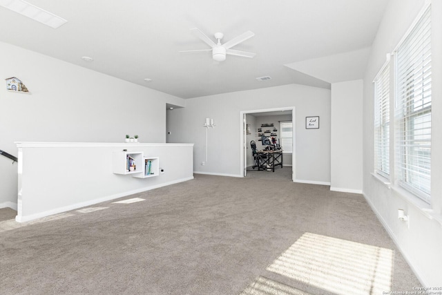 unfurnished living room with ceiling fan, visible vents, baseboards, and carpet flooring