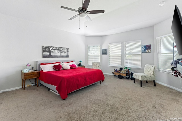 carpeted bedroom with ceiling fan and baseboards