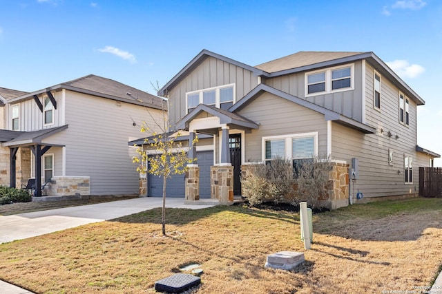 view of front of property with board and batten siding, a front yard, driveway, and a garage