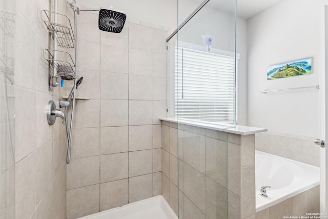 bathroom with a tile shower and a bath