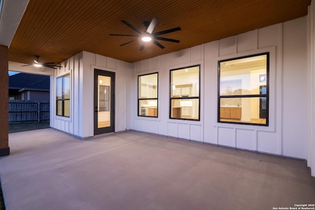 view of patio with ceiling fan and fence