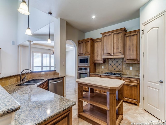 kitchen with light tile patterned floors, tasteful backsplash, stainless steel appliances, open shelves, and a sink