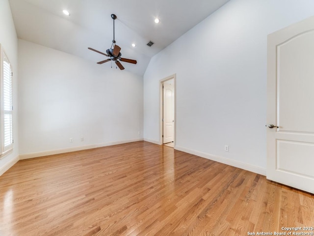 empty room with light wood-style flooring, recessed lighting, a ceiling fan, baseboards, and vaulted ceiling