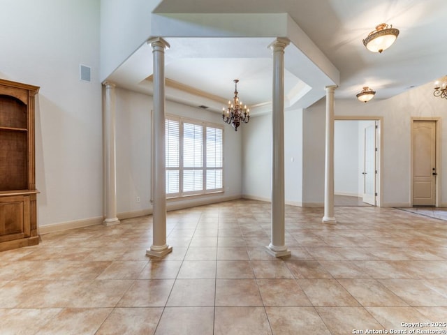 unfurnished living room with ornate columns, baseboards, visible vents, and a raised ceiling