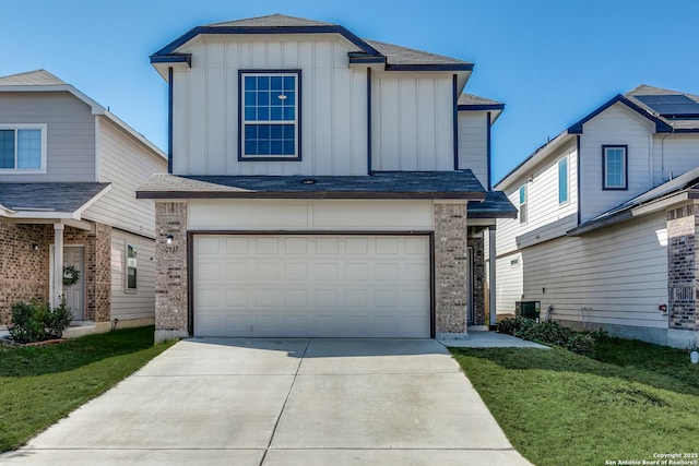 10537 Green Lk, San Antonio, TX 78223 - view of front facade featuring brick siding, concrete driveway, an attached garage, board and batten siding, and central AC