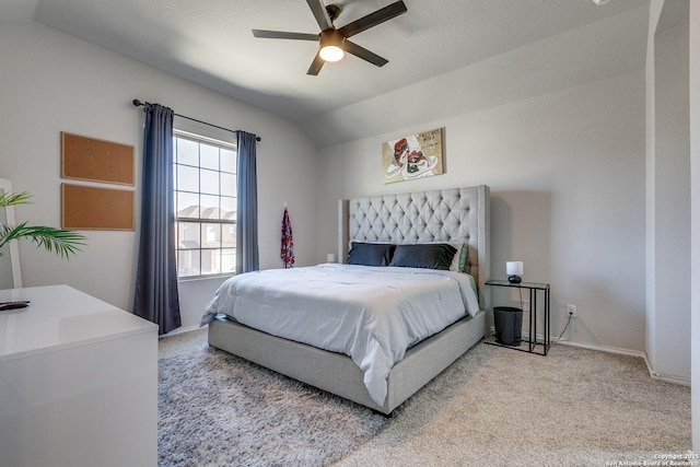 bedroom featuring light carpet, ceiling fan, baseboards, and vaulted ceiling