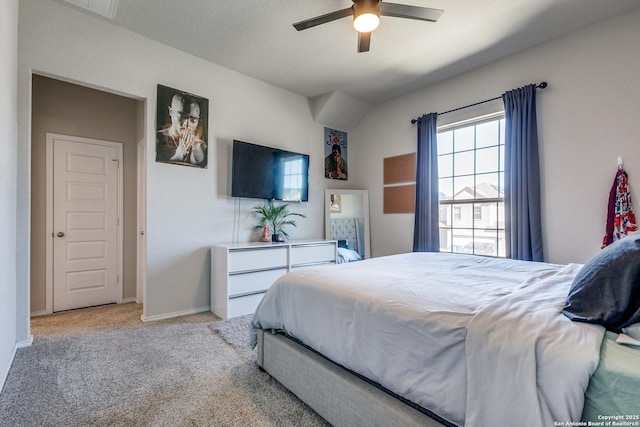 bedroom with ceiling fan, baseboards, and light colored carpet