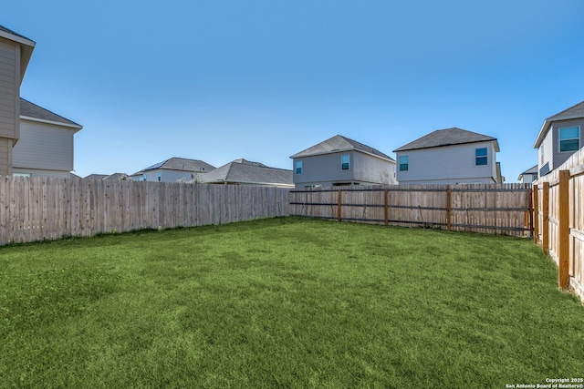 view of yard with a fenced backyard