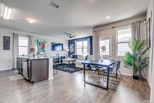 dining space with plenty of natural light, wood finished floors, and visible vents