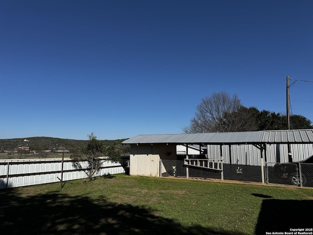 dock area featuring a lawn and fence