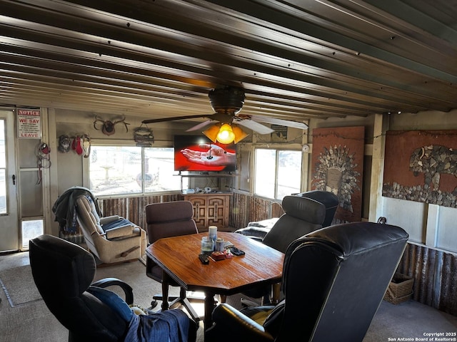 carpeted living area featuring ceiling fan