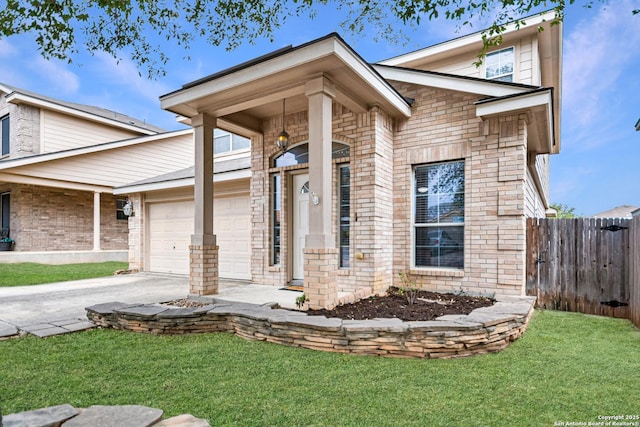 view of front of home with a front yard, fence, concrete driveway, and brick siding