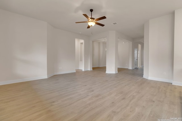 unfurnished room with a ceiling fan, baseboards, visible vents, and light wood finished floors