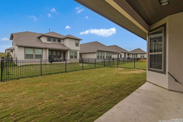 view of yard with a residential view and a fenced backyard