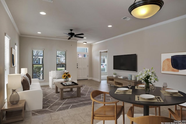 living area with visible vents, crown molding, and tile patterned floors