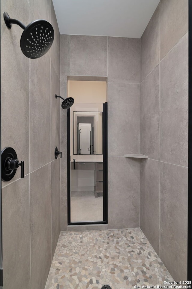 full bath with a tile shower