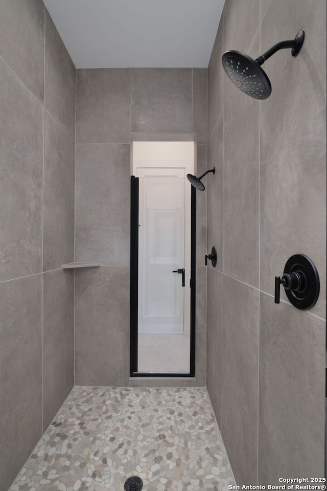 full bathroom with a tile shower