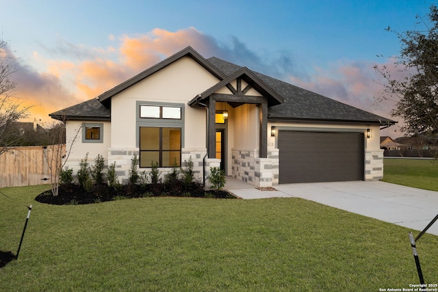 view of front of house featuring a garage, a lawn, driveway, and stucco siding