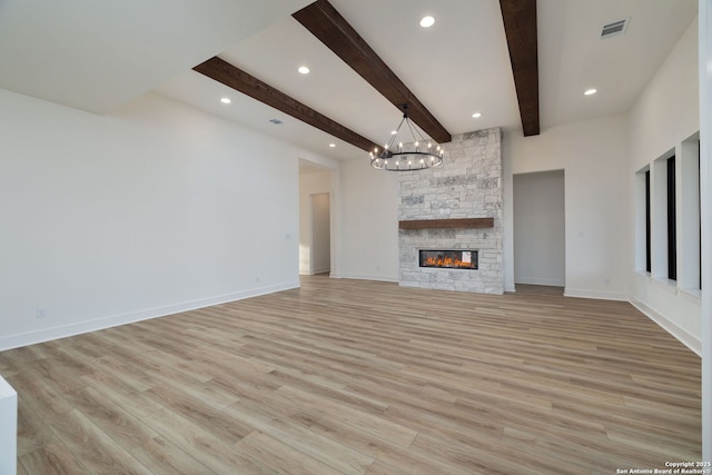 unfurnished living room featuring a stone fireplace, light wood-type flooring, visible vents, and baseboards