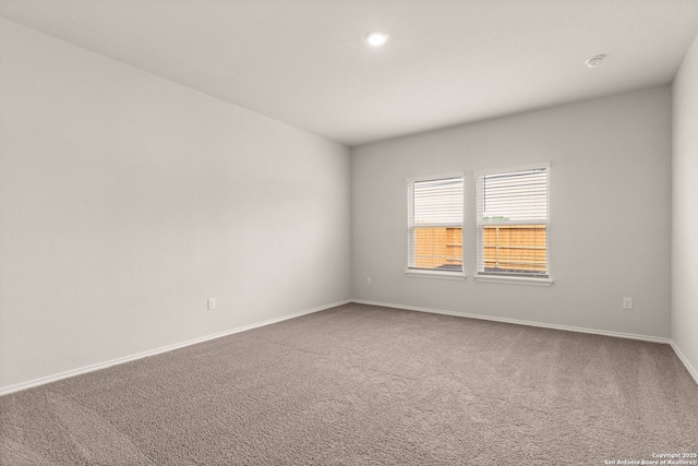 carpeted spare room with baseboards