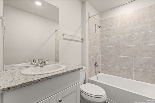 full bath featuring  shower combination, vanity, and toilet