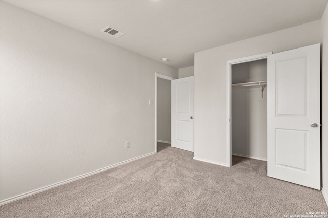 unfurnished bedroom with a closet, baseboards, visible vents, and carpet flooring