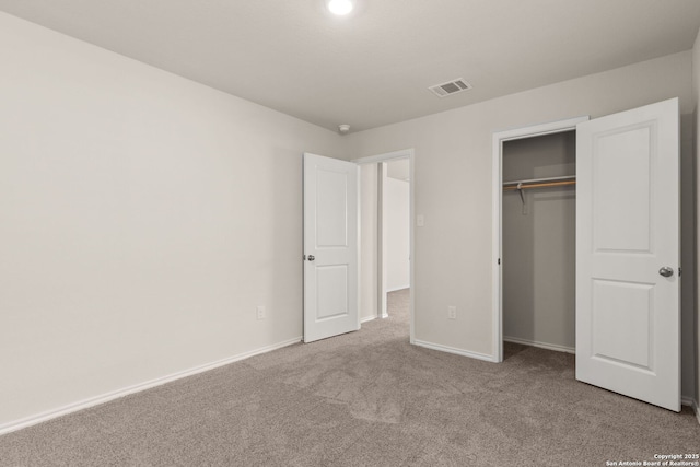 unfurnished bedroom with carpet floors, baseboards, visible vents, and a closet