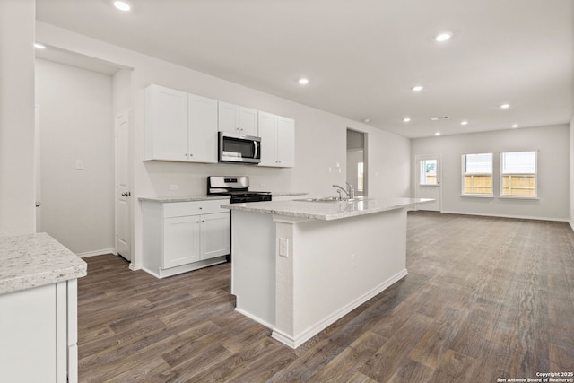 kitchen featuring white cabinetry, appliances with stainless steel finishes, dark wood-type flooring, and recessed lighting