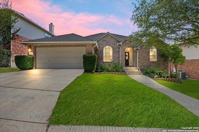 25723 Preserve Crst, San Antonio, TX 78261 - view of front of house with a garage, driveway, a lawn, and brick siding