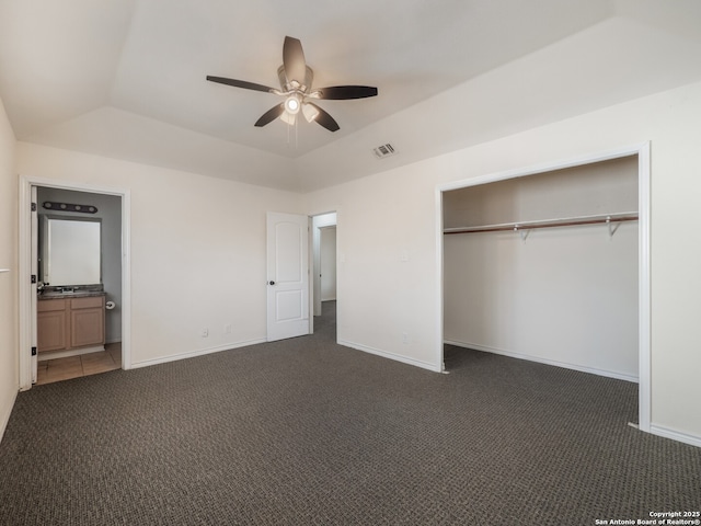 unfurnished bedroom featuring dark colored carpet, a closet, visible vents, and baseboards