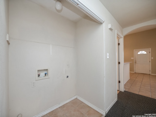 laundry room with arched walkways, light tile patterned flooring, hookup for an electric dryer, laundry area, and washer hookup