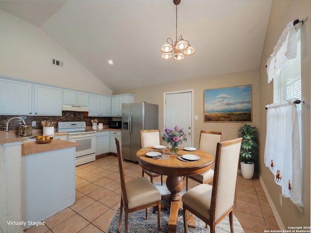 kitchen featuring under cabinet range hood, electric range, a sink, light countertops, and stainless steel fridge with ice dispenser