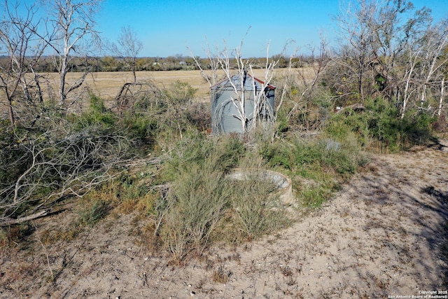 view of yard with a rural view