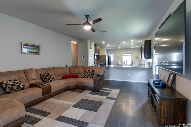 living area with dark wood-type flooring, a ceiling fan, visible vents, and recessed lighting