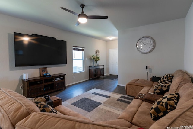 living area featuring a ceiling fan, baseboards, and wood finished floors