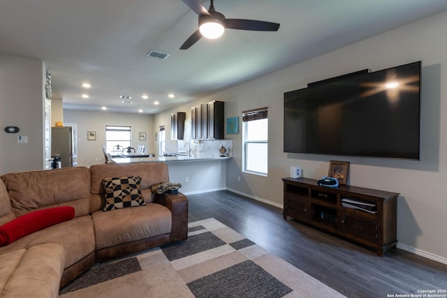 living area with baseboards, visible vents, dark wood finished floors, a ceiling fan, and recessed lighting