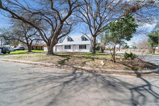 view of front of house with metal roof and driveway