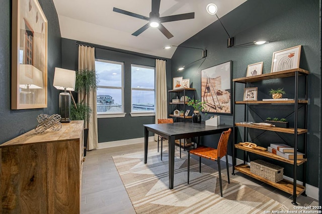 dining area featuring vaulted ceiling, ceiling fan, light wood-style flooring, and baseboards