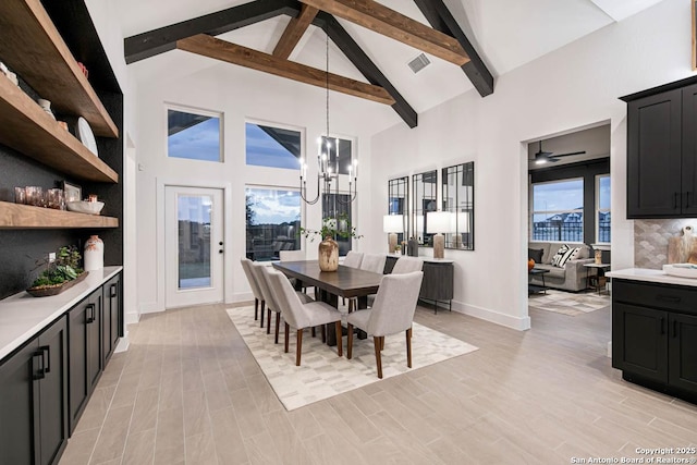 dining room with light wood finished floors, high vaulted ceiling, a notable chandelier, and beamed ceiling