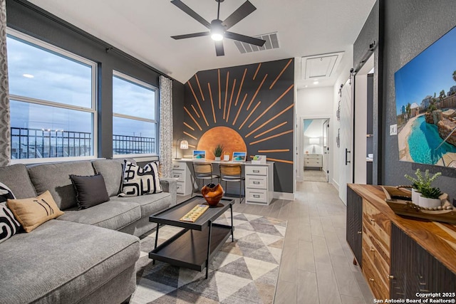 living room with visible vents, an accent wall, ceiling fan, light wood-type flooring, and baseboards