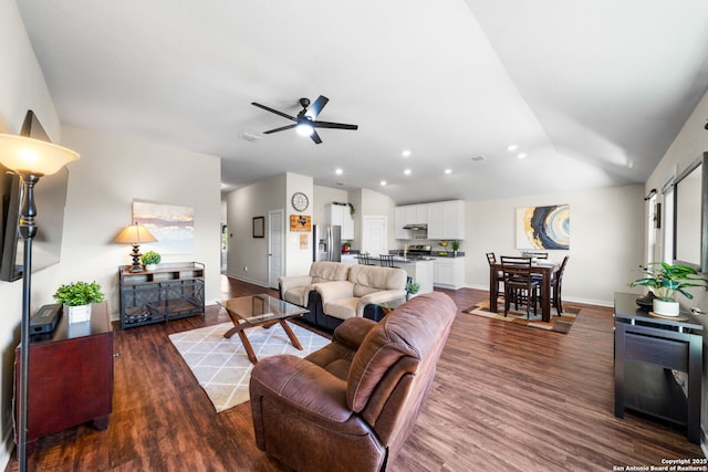 living area with lofted ceiling, recessed lighting, wood finished floors, a ceiling fan, and baseboards