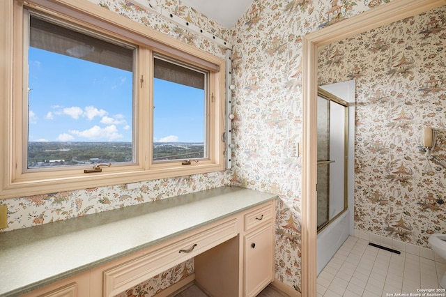 bathroom featuring enclosed tub / shower combo, tile patterned flooring, visible vents, baseboards, and wallpapered walls