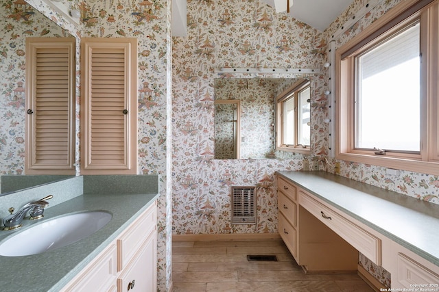 full bath featuring wallpapered walls, visible vents, wood finished floors, and vanity