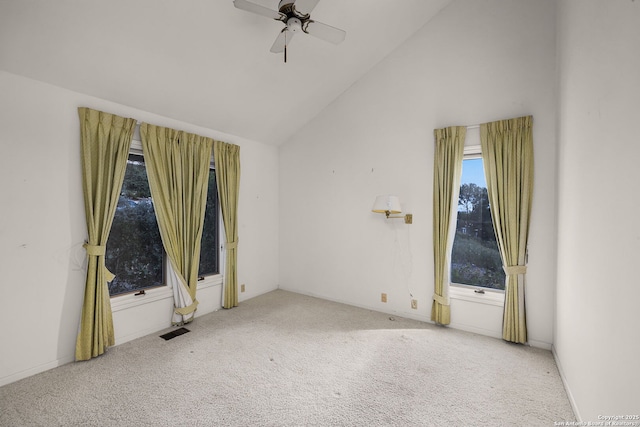 unfurnished room with high vaulted ceiling, carpet, visible vents, and a ceiling fan