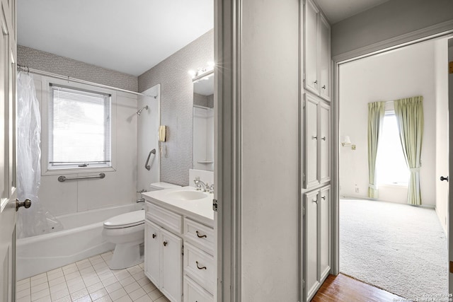 bathroom featuring tile patterned flooring, vanity, toilet, and shower / bath combo with shower curtain